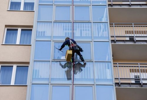 [freepicdownloader.com]-industrial-mountaineering-worker-uniform-washing-exterior-glazing-normal