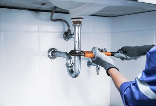 [freepicdownloader.com]-plumber-using-wrench-repair-water-pipe-sink-normal